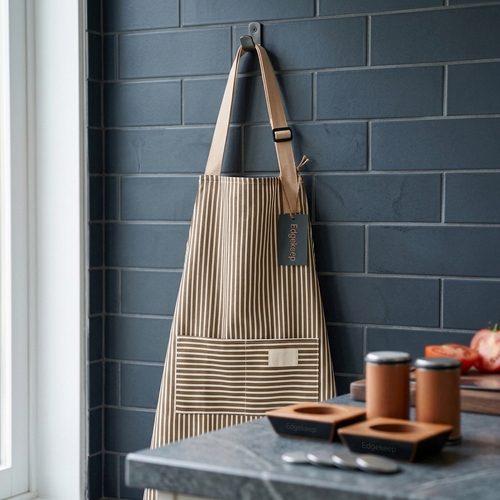Striped kitchen apron hanging in a kitchen beside Edgekeep