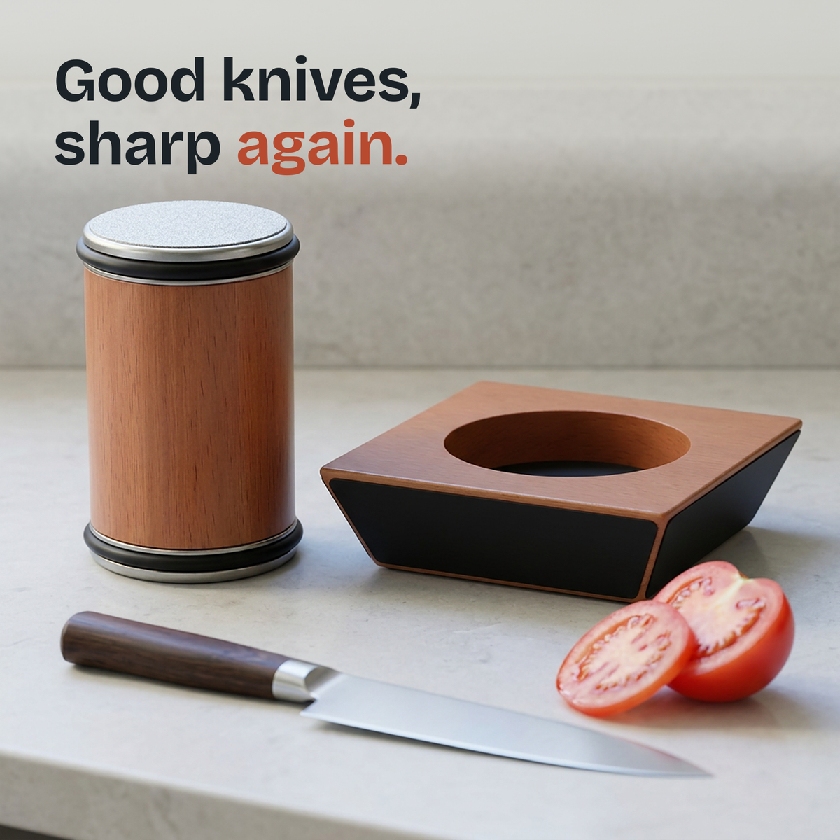 A chef's knife resting on the Edgekeep magnetic block beside a sliced tomato