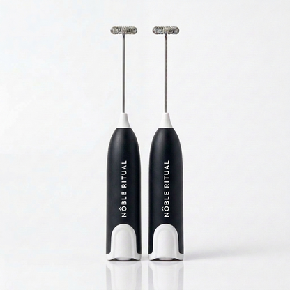 Noble Frothé Set of 2 in Two Black: two black frothers with white collars and bases, vertical white NÔBLE RITUAL wordmarks and coiled steel whisks