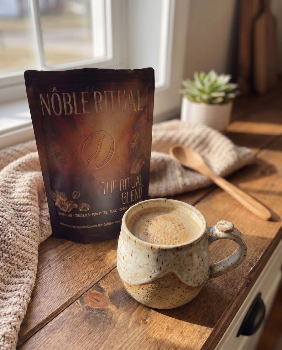 Noble Ritual Blend bag and a mug of coffee by a window.