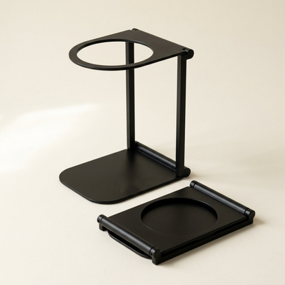 Noble Perche foldable espresso stand in matte black, standing open beside a second one folded flat