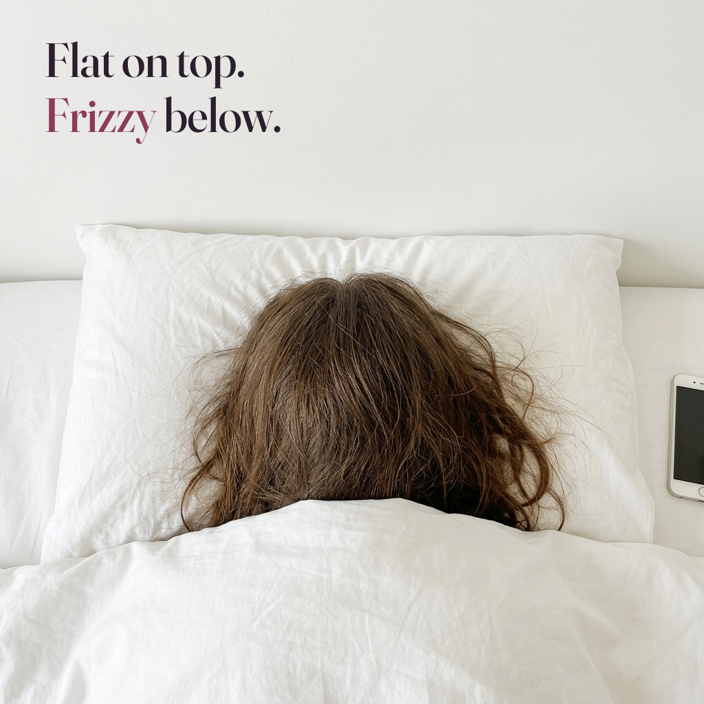 Flat on top, frizzy below. The back of a woman's head with flat, frizzy hair on a plain white cotton pillowcase